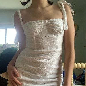 white lace eyelet mini dress from the brand lioness